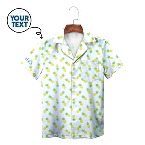 White Hawaiian shirt with yellow pineapple pattern on hanger